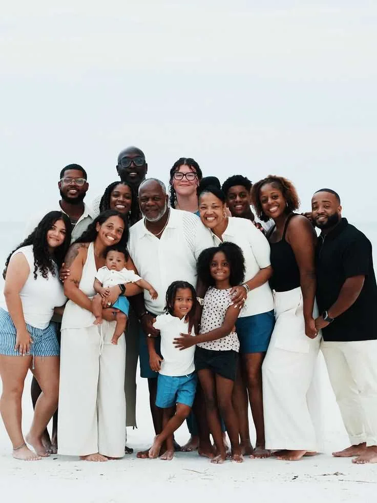 The Johnson family portrait smiling together outdoors